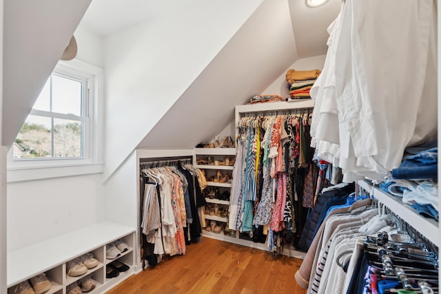 walk in closet with lofted ceiling and light hardwood / wood-style floors