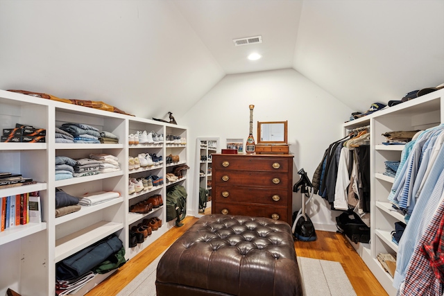 walk in closet featuring vaulted ceiling and light hardwood / wood-style floors