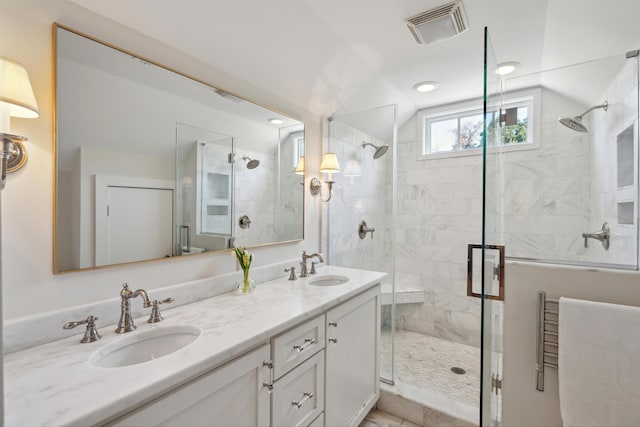 bathroom featuring vanity, vaulted ceiling, and walk in shower