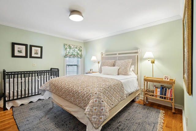 bedroom featuring hardwood / wood-style floors and ornamental molding