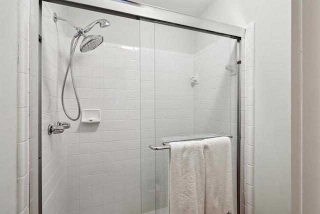 bathroom with a shower with shower door