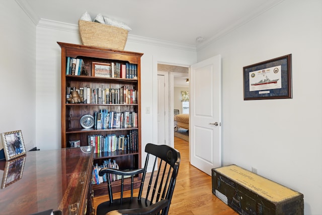 office area with ornamental molding and light hardwood / wood-style flooring