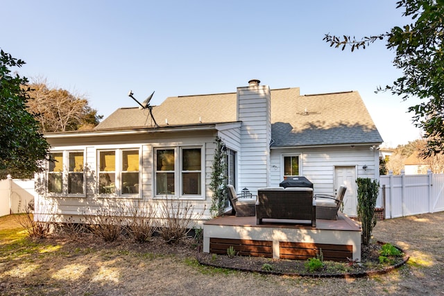 back of house with a wooden deck