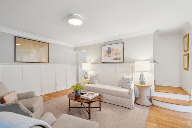 living room with crown molding and light hardwood / wood-style floors