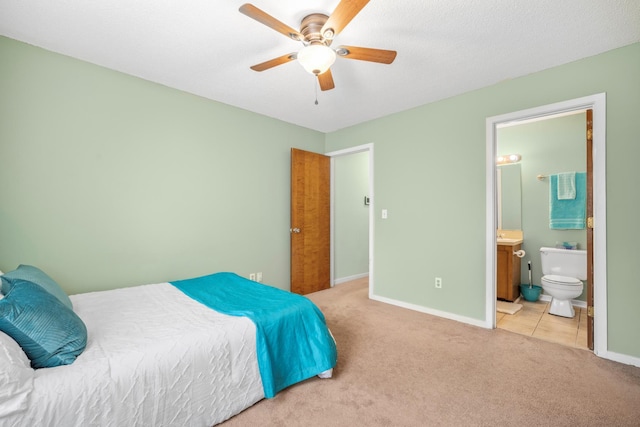 6231 Rolling Fork Rd Unit 1201-A, North Charleston, SC 29406 - tiled bedroom featuring carpet flooring, baseboards, ensuite bathroom, and ceiling fan