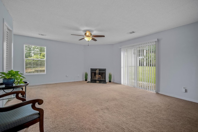 6231 Rolling Fork Rd Unit 1201-A, North Charleston, SC 29406 - living room with a ceiling fan, carpet floors, a textured ceiling, a fireplace with flush hearth, and baseboards