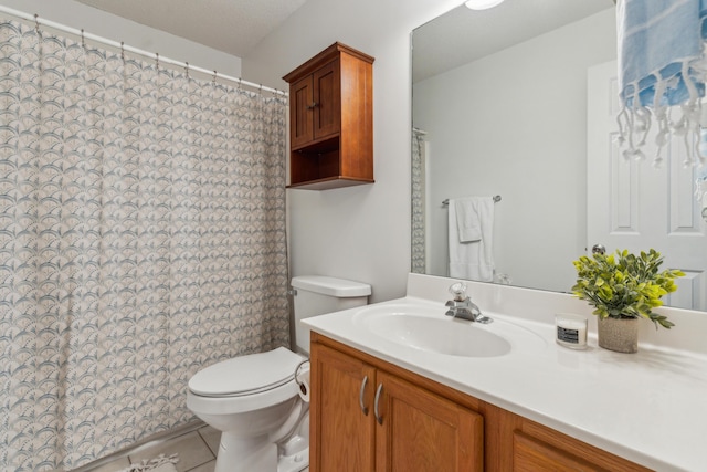 bathroom with tile patterned flooring, toilet, and vanity