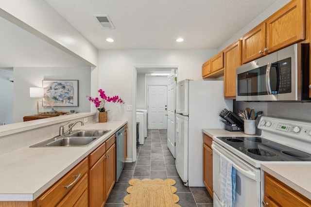 kitchen with a sink, light countertops, visible vents, and stainless steel appliances