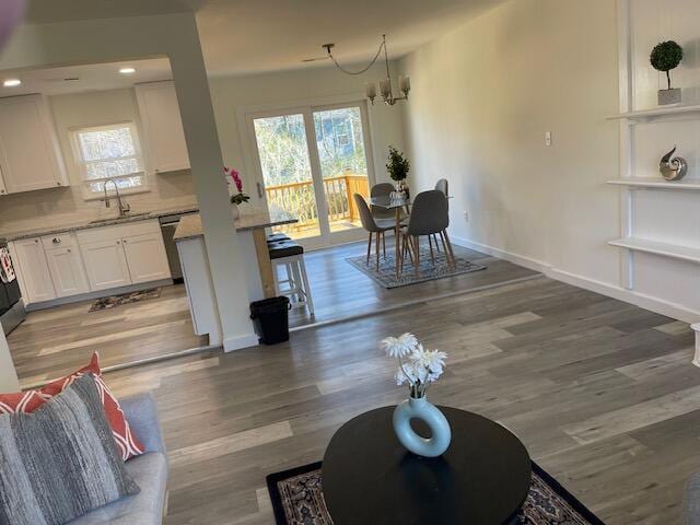 interior space featuring a notable chandelier, sink, and light hardwood / wood-style floors