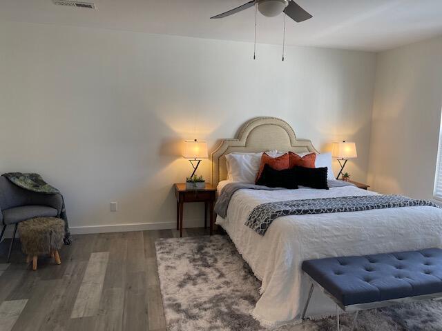 bedroom with ceiling fan and wood-type flooring