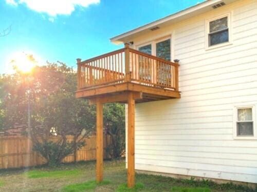 back of property with a wooden deck