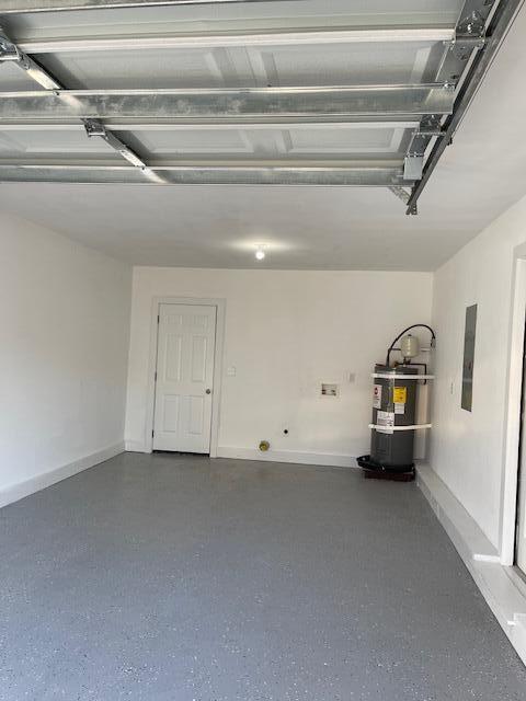 garage featuring secured water heater and electric panel