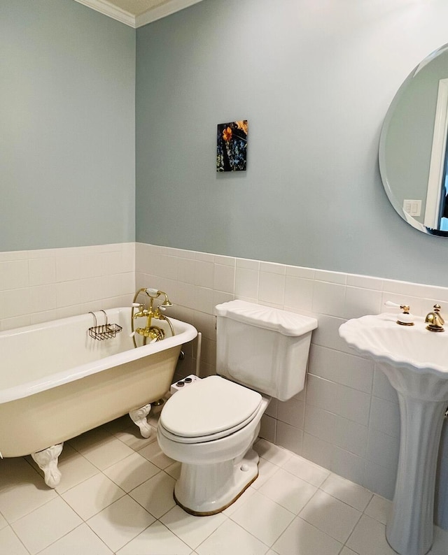 bathroom with a bathtub, tile walls, crown molding, tile patterned flooring, and toilet