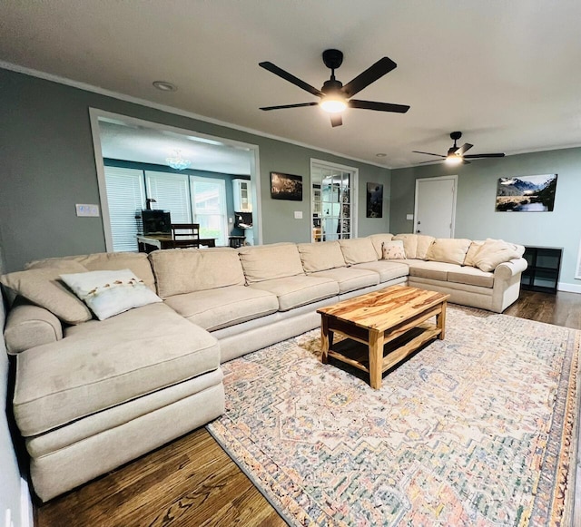 living room featuring hardwood / wood-style flooring, ceiling fan, and crown molding