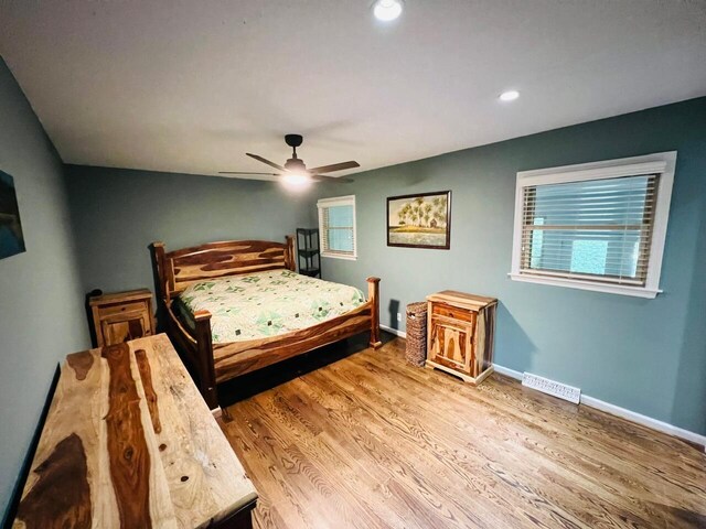 bedroom with hardwood / wood-style floors and ceiling fan