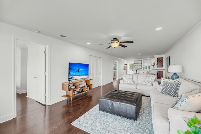 living area with ceiling fan, wood finished floors, recessed lighting, baseboards, and ornamental molding