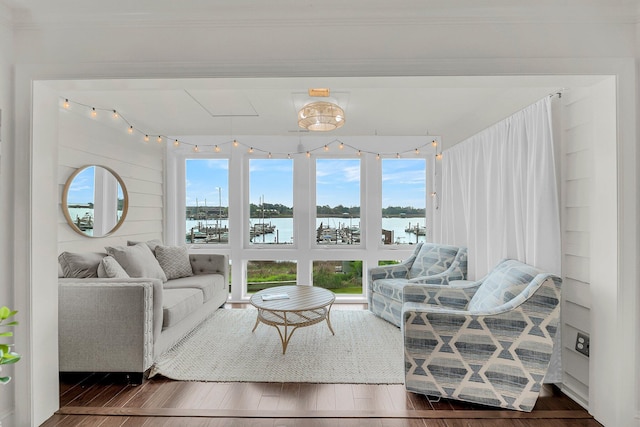living room with wood finished floors and a water view