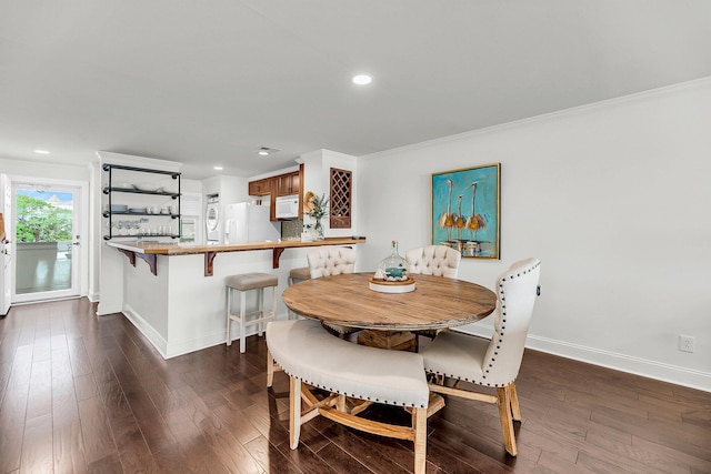 dining space featuring baseboards, dark wood-style flooring, recessed lighting, and crown molding