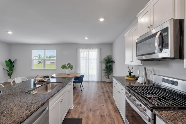 411 Bering Ln, Summerville, SC 29486 - kitchen with stainless steel appliances, a sink, dark stone countertops, recessed lighting, and white cabinets