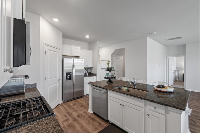 411 Bering Ln, Summerville, SC 29486 - kitchen featuring stainless steel appliances, a sink, wood finished floors, white cabinetry, and recessed lighting