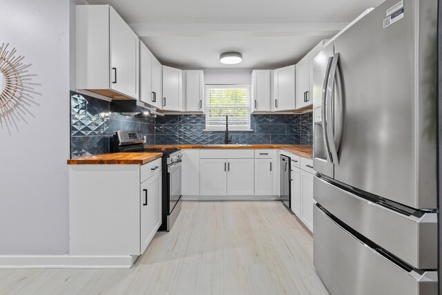 867 Colony Dr Unit F92, Charleston, SC 29407 - kitchen featuring appliances with stainless steel finishes, butcher block counters, a sink, light wood-style floors, and decorative backsplash
