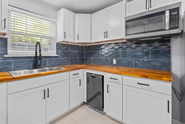867 Colony Dr Unit F92, Charleston, SC 29407 - kitchen with wooden counters, stainless steel microwave, black dishwasher, a sink, and white cabinets