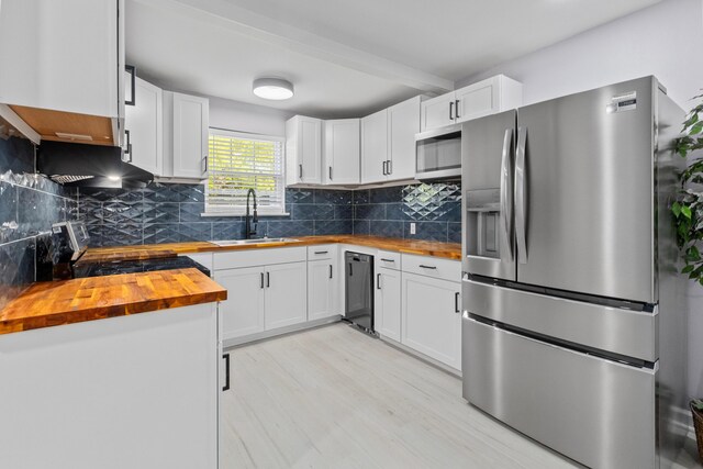 867 Colony Dr Unit F92, Charleston, SC 29407 - kitchen with wooden counters, appliances with stainless steel finishes, a sink, under cabinet range hood, and tasteful backsplash