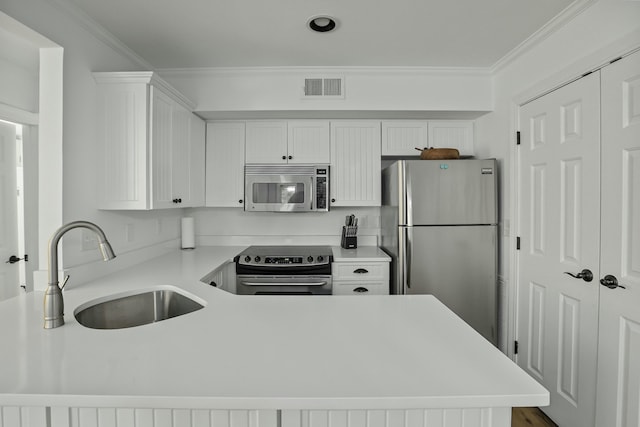 kitchen featuring visible vents, white cabinets, appliances with stainless steel finishes, light countertops, and a sink