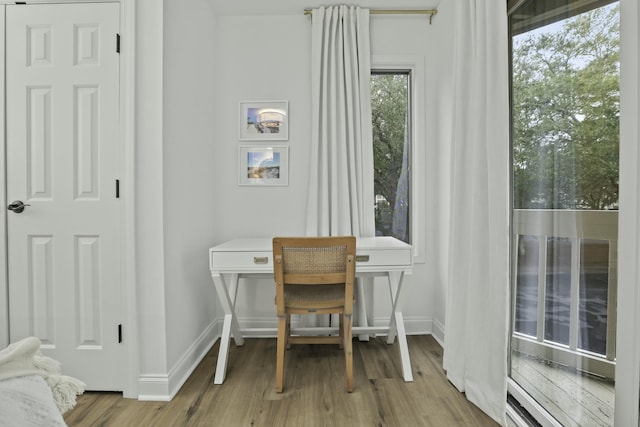 office space featuring light wood-type flooring and baseboards