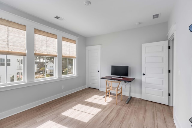 interior space featuring visible vents, baseboards, and wood finished floors