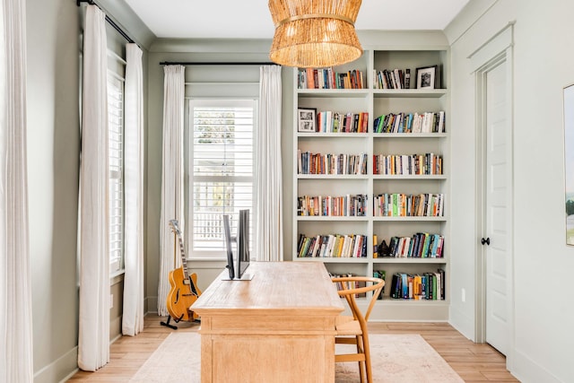 home office with baseboards and wood finished floors