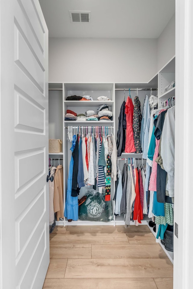 walk in closet featuring wood finished floors and visible vents