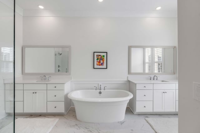 full bathroom featuring marble finish floor, a stall shower, two vanities, and a sink