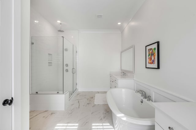 bathroom with vanity, a freestanding tub, a shower stall, crown molding, and marble finish floor