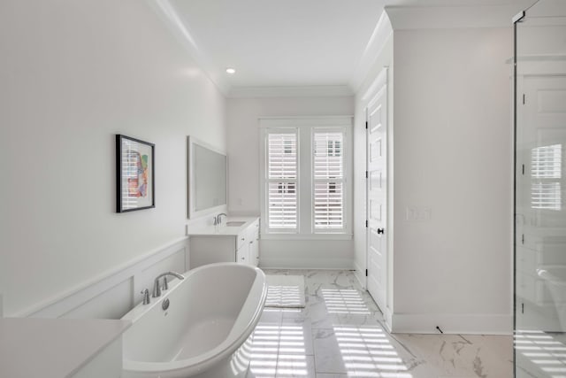 full bathroom featuring wainscoting, marble finish floor, a freestanding bath, and crown molding