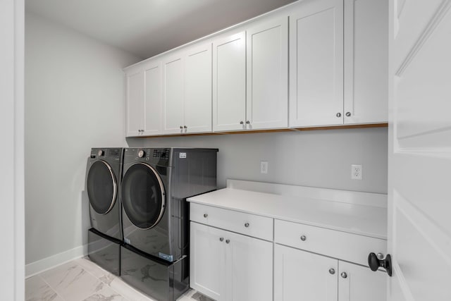 laundry room with cabinet space, marble finish floor, baseboards, and separate washer and dryer