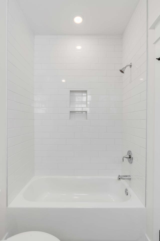 bathroom with toilet and washtub / shower combination