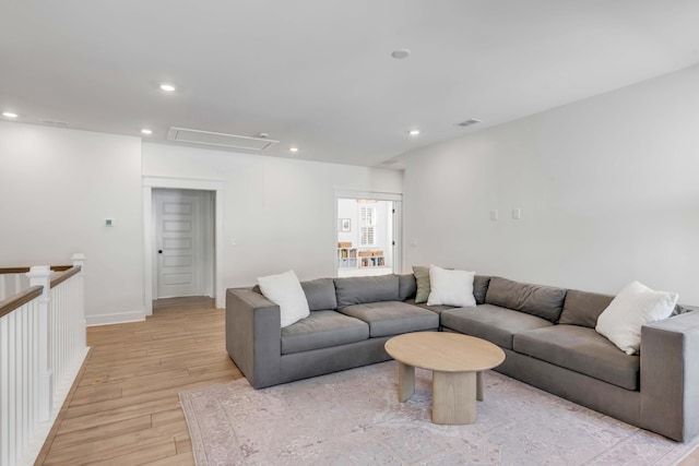 living room with light wood finished floors, recessed lighting, attic access, and baseboards