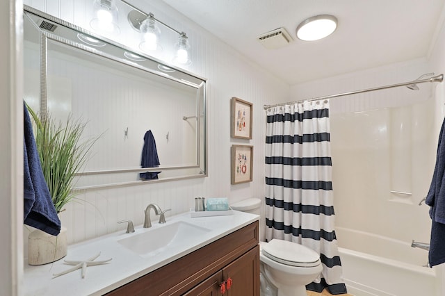 full bathroom with visible vents, crown molding, toilet, shower / tub combo, and vanity