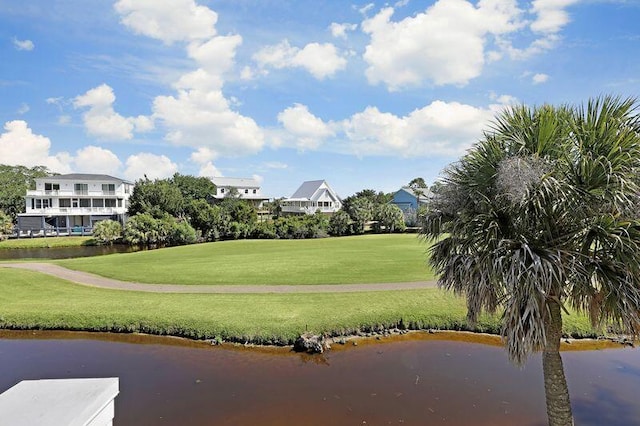 view of home's community featuring a water view and a lawn