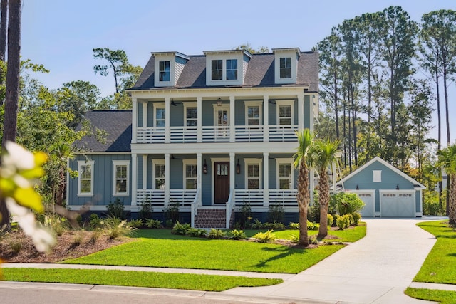 view of front of property featuring a garage, an outdoor structure, a front yard, and a porch