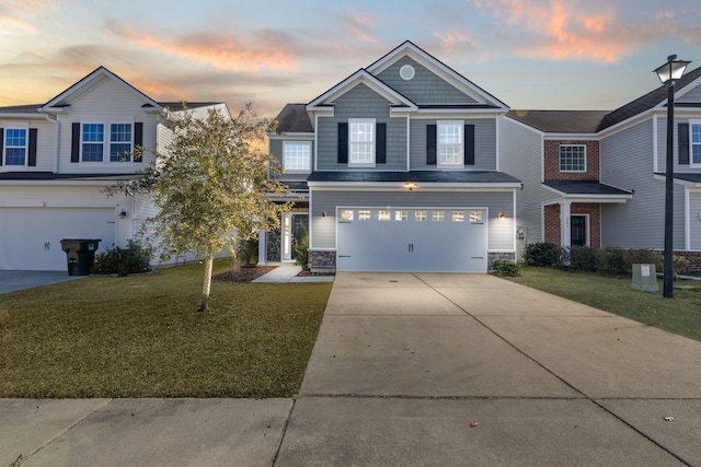 view of front of property featuring a garage and a lawn