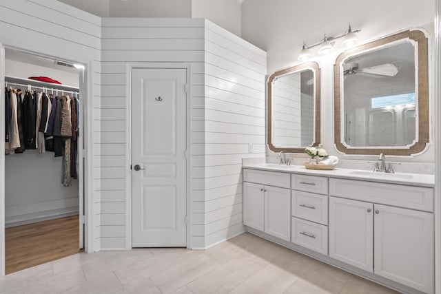 116 Cartright St, Daniel Island, SC 29492 - bathroom with double vanity, a walk in closet, a shower, a ceiling fan, and tile patterned flooring