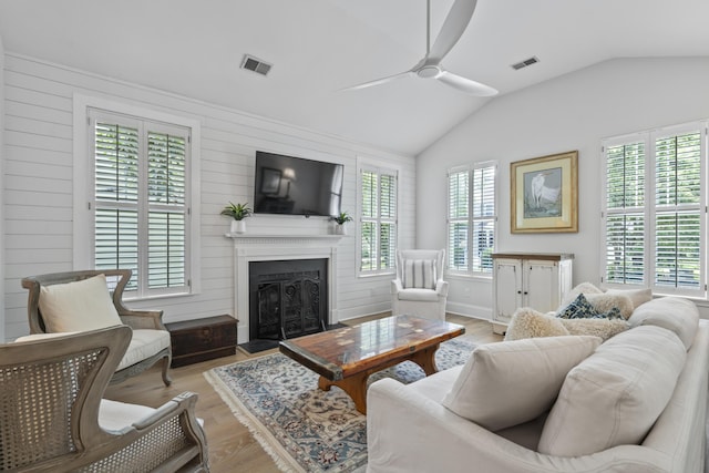 116 Cartright St, Daniel Island, SC 29492 - living room featuring ceiling fan, vaulted ceiling, a fireplace with flush hearth, and light wood-type flooring