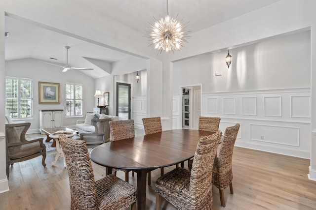 116 Cartright St, Daniel Island, SC 29492 - dining space featuring a decorative wall, light wood-type flooring, a chandelier, vaulted ceiling, and wainscoting