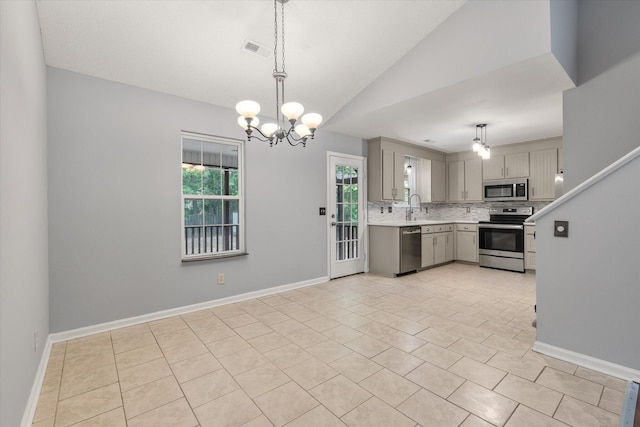 kitchen with stainless steel appliances, gray cabinets, light countertops, light tile patterned floors, and a sink