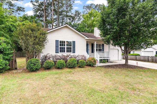 view of front of house with a porch, driveway, an attached garage, and a chimney