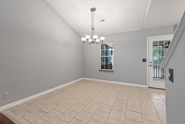 empty room featuring lofted ceiling, plenty of natural light, a chandelier, light tile patterned floors, and baseboards