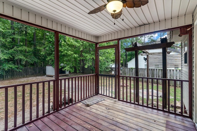 unfurnished sunroom with ceiling fan