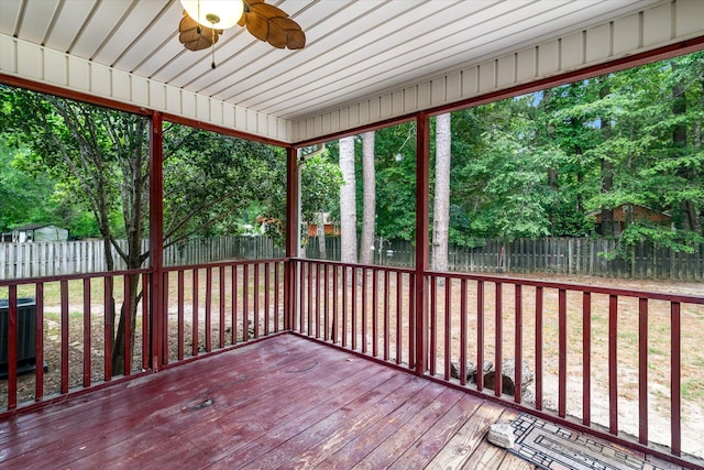 unfurnished sunroom with ceiling fan